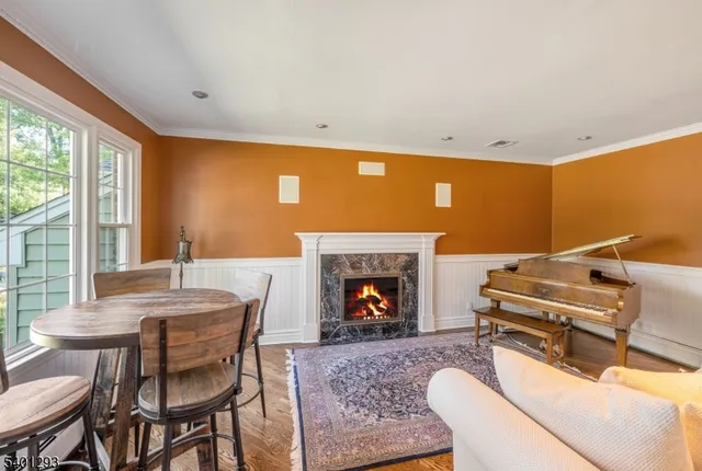 a living room with furniture a fireplace and a large window