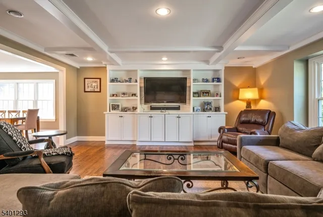 a room with furniture pool table and a flat screen tv