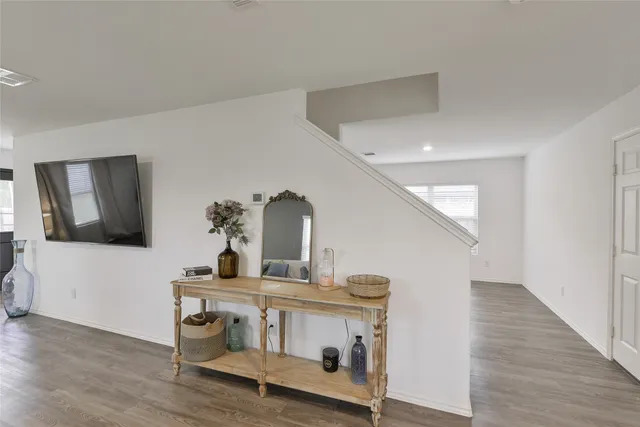 a view of living room with furniture and wooden floor