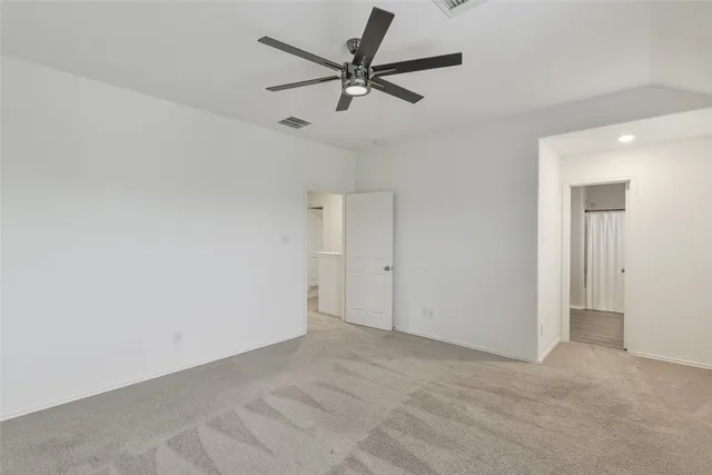 a view of a livingroom with a ceiling fan and window