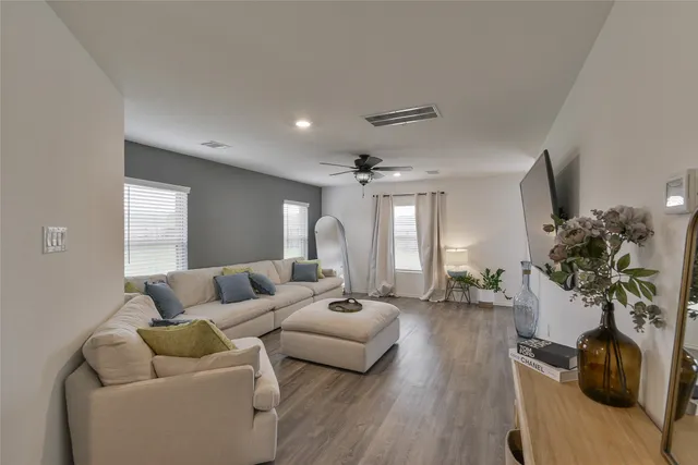 a living room with furniture and wooden floor