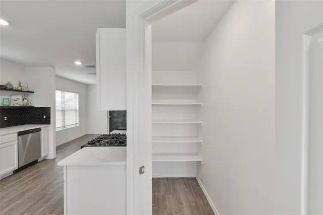 a kitchen with a refrigerator and a stove top oven