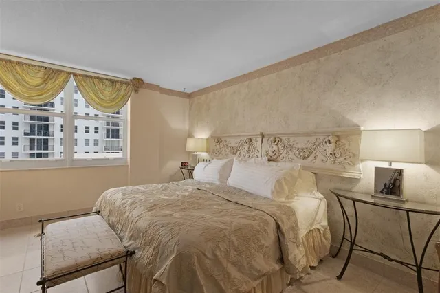 a bedroom with furniture and a flat screen tv