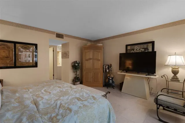 a bedroom with a bed and a lamp on table