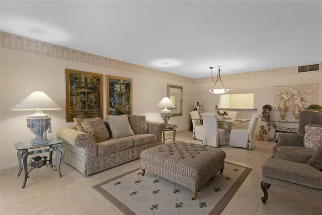 a living room with furniture and a lamp