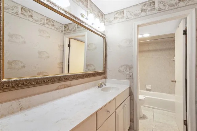 a white toilet sitting next to a white sink