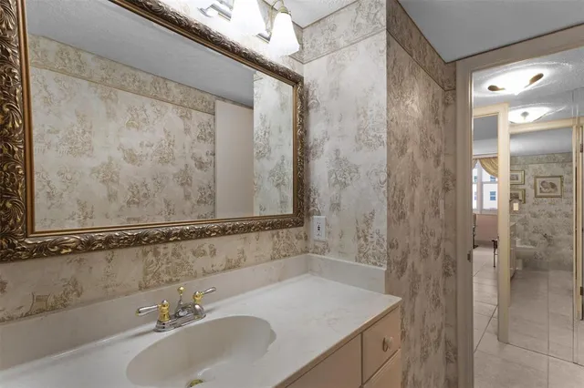 a view of a hallway with chandelier fan and glass door