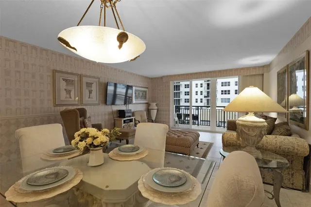 a living room with furniture a window and a chandelier