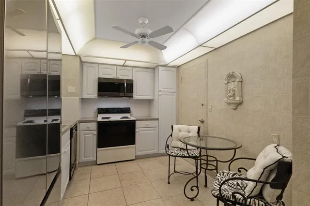 a kitchen with stainless steel appliances granite countertop a stove and a refrigerator