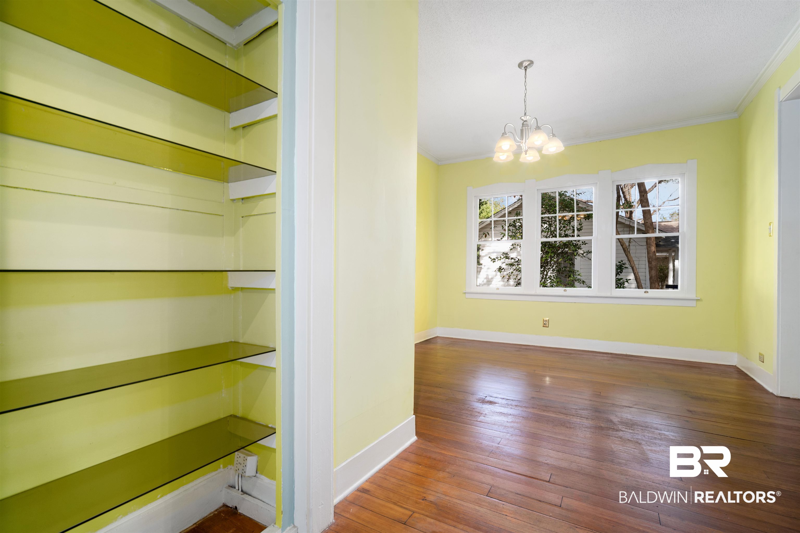118 Mohawk Street Mobile, AL 36606 - Photo 17 of 26 Unfurnished dining area featuring crown molding, hanging lights, and dark wood-style flooring
