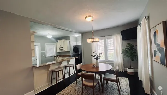 a kitchen with a table and chairs in it