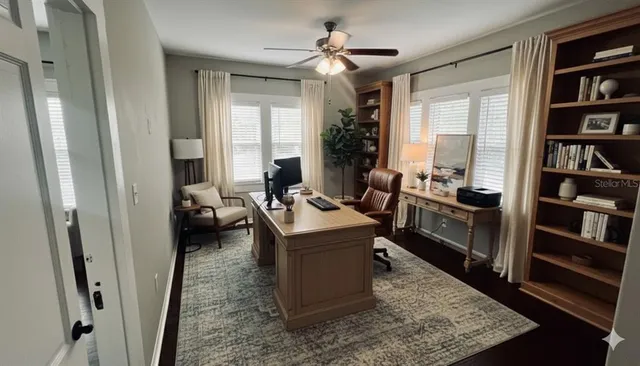 a living room with furniture and a book shelf