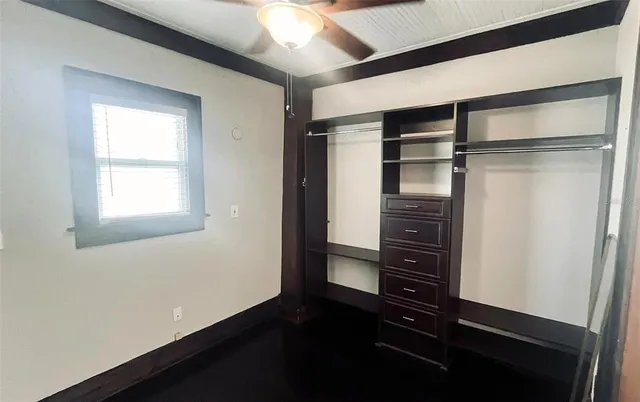 a view of walk in closet with wooden floor
