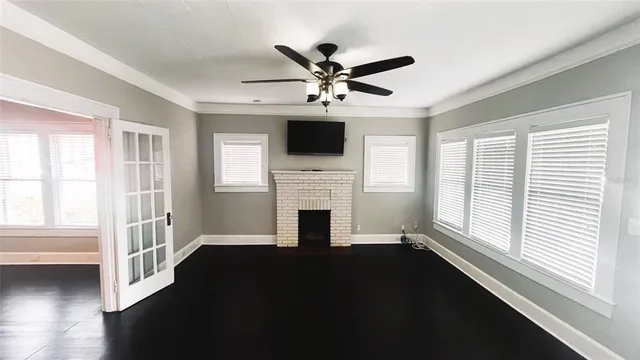 a living room with fireplace fireplace and windows