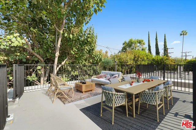 a view of a patio with a table and chairs