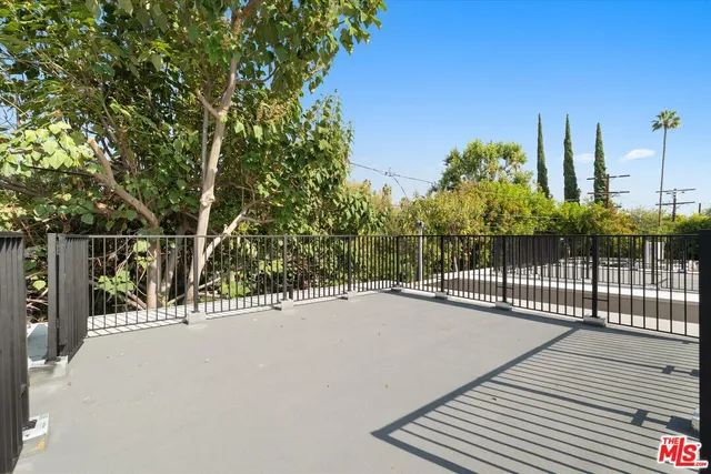 a view of a park with iron fence