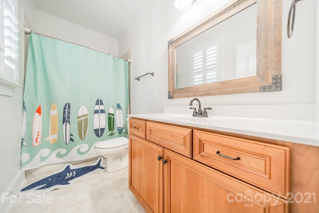 785 Shady Grove Crossing Fort Mill, SC 29708 - Photo 22 of 48 a bathroom with a sink a mirror and a shower