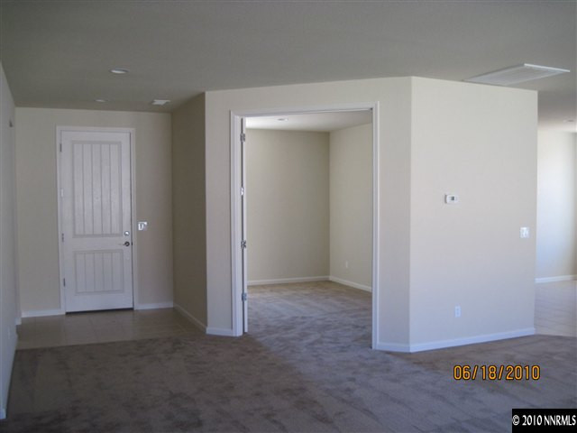 1491 Hogadon Way Reno, NV 89523 - Photo 3 of 5 an empty room with wooden floor and closet