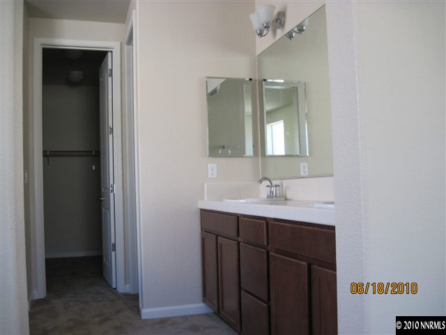 1491 Hogadon Way Reno, NV 89523 - Photo 4 of 5 a bathroom with a double vanity sink and mirror