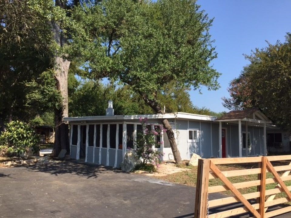 a view of backyard with deck and outdoor seating