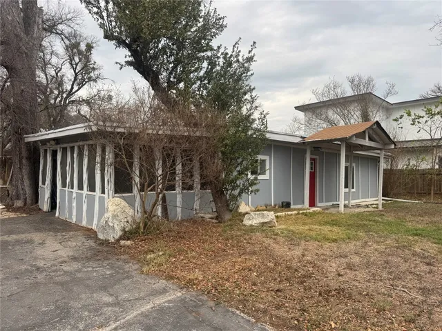 a view of a house with backyard porch and sitting area