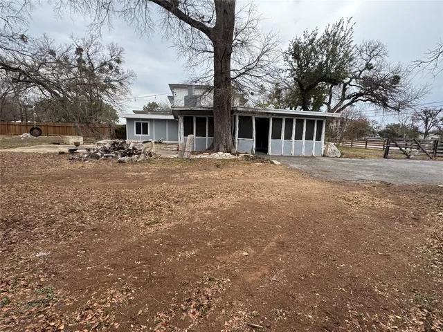 a view of a yard with a house and a tree