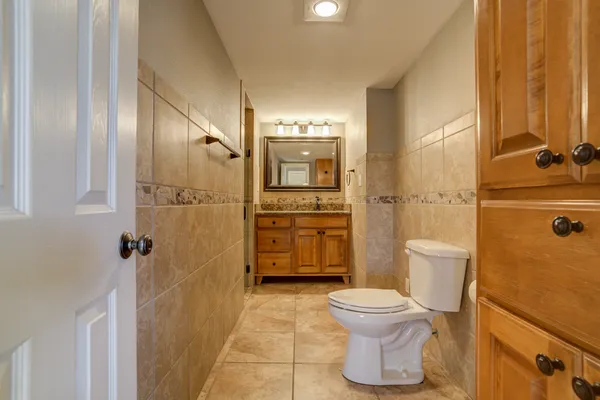 a bathroom with a granite countertop sink a mirror and shower