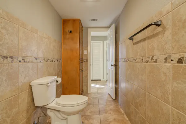 a kitchen with granite countertop white cabinets stainless steel appliances and sink