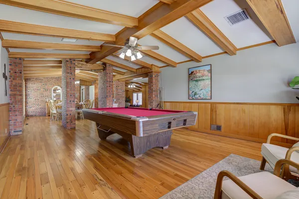 a dining room with furniture and wooden floor