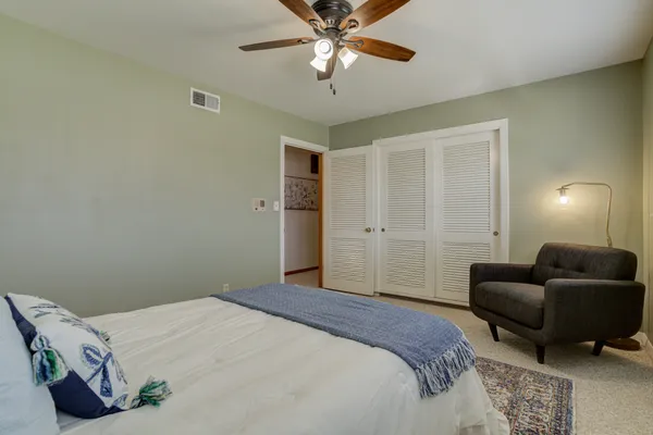a spacious bedroom with a bed and window