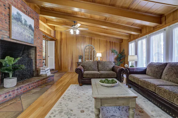 a living room with furniture and a potted plant