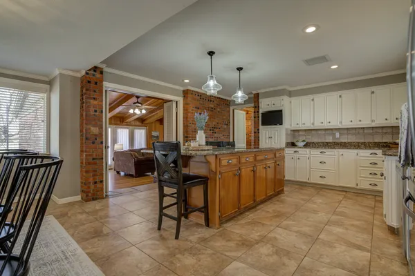 a kitchen with granite countertop a sink stove and refrigerator