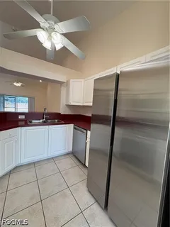a kitchen with stainless steel appliances a refrigerator sink and cabinets