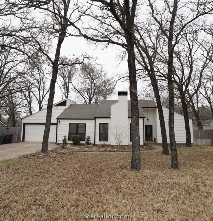 a front view of a house with a tiny tree
