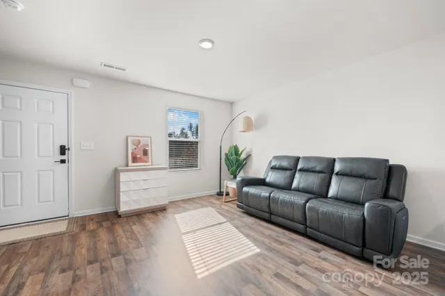 a living room with furniture and painting on the wall
