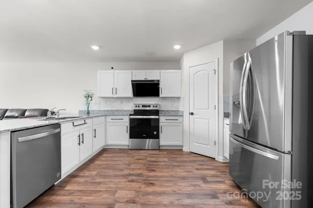 a kitchen with a refrigerator sink and microwave