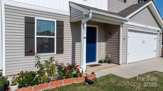 a view of a house with potted plants