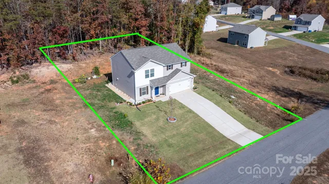 an aerial view of a house with a yard