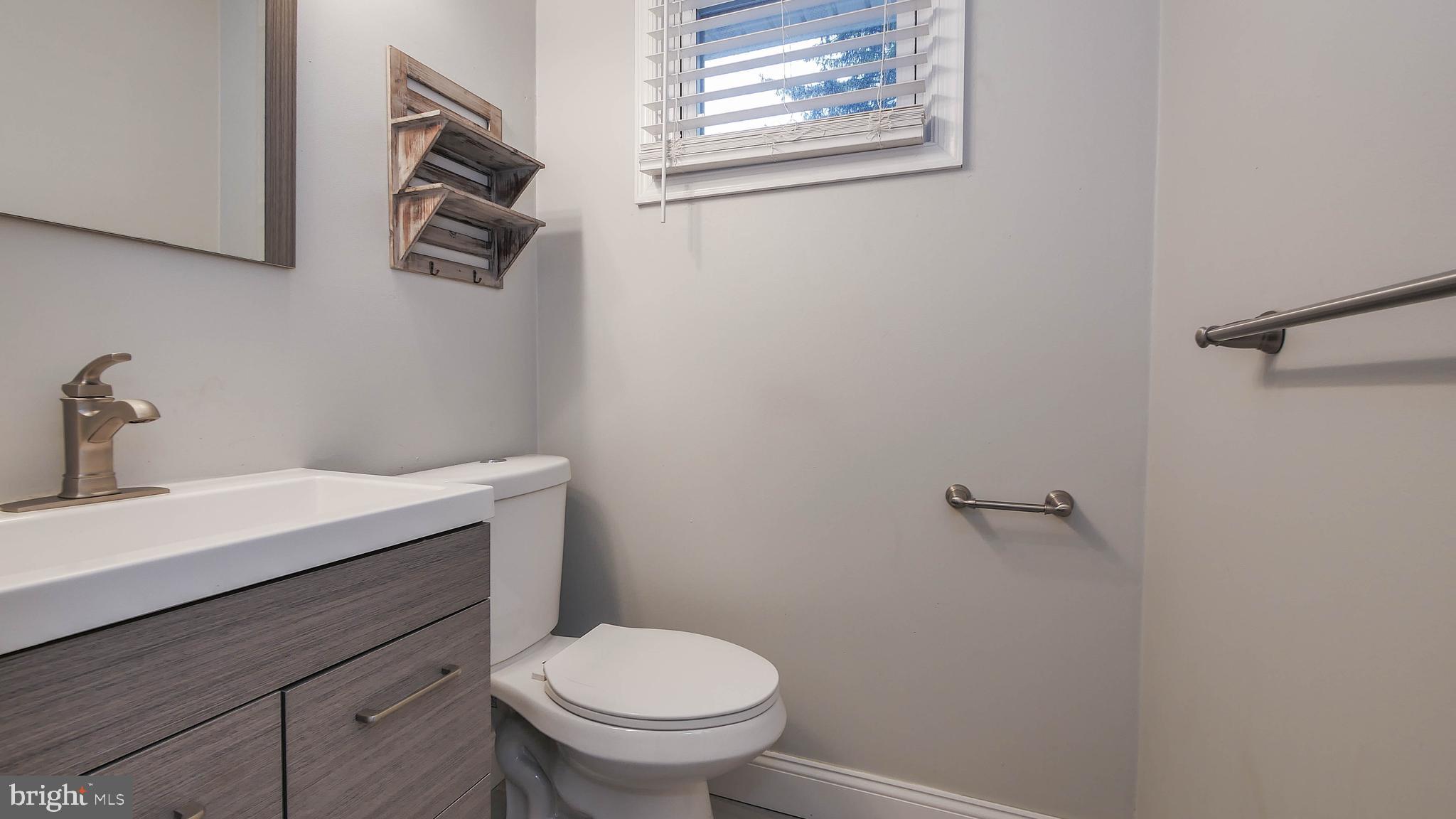 2 Clement Drive Somerdale, NJ 08083 - Photo 11 of 22 a bathroom with a sink a toilet and mirror