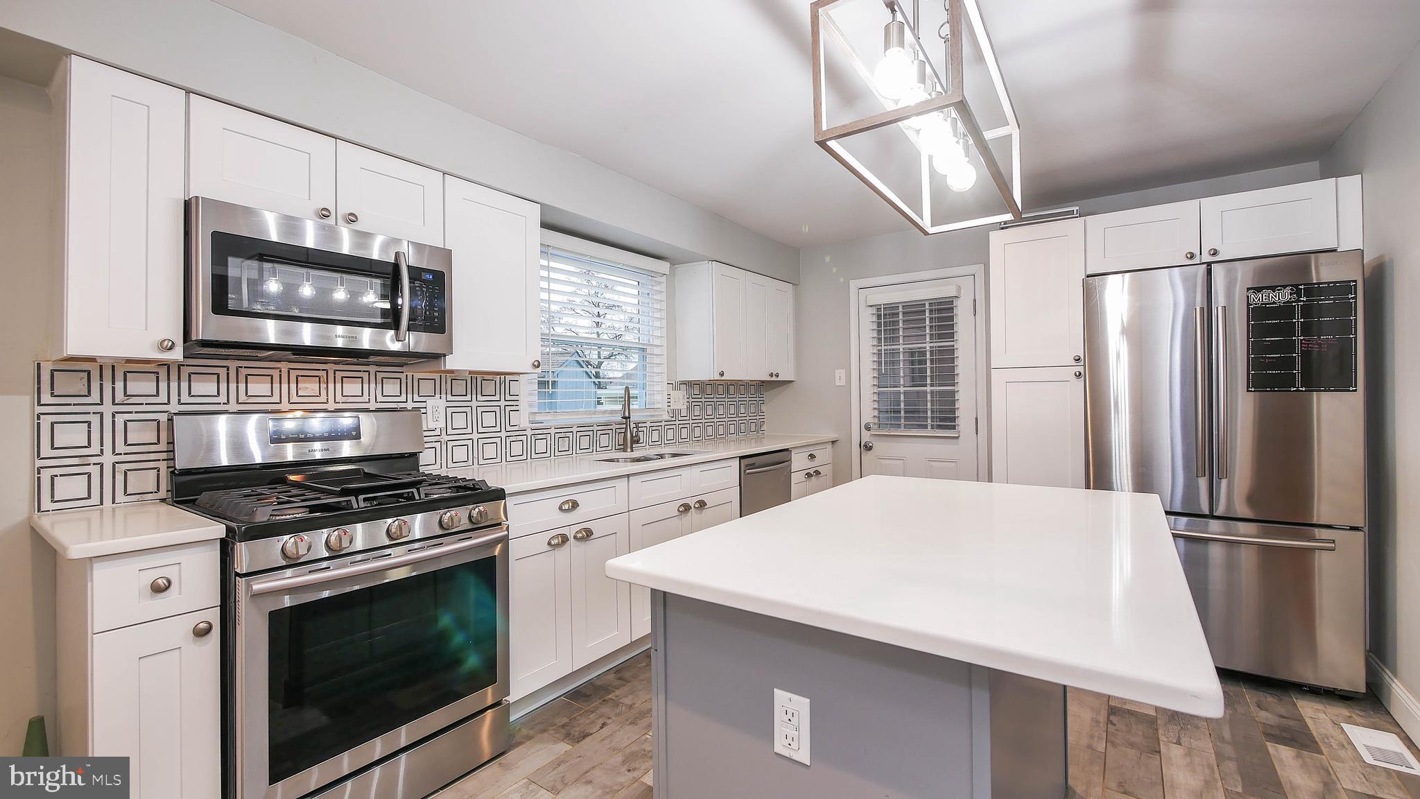 2 Clement Drive Somerdale, NJ 08083 - Photo 14 of 22 a kitchen with stainless steel appliances a stove microwave and a refrigerator