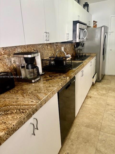 100 Lincoln Road, Unit 531 Miami Beach, FL 33139 - Photo 7 of 31 a kitchen with granite countertop a sink and a stove