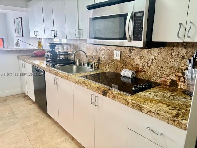 100 Lincoln Road, Unit 531 Miami Beach, FL 33139 - Photo 8 of 31 a kitchen with granite countertop a sink and a stove