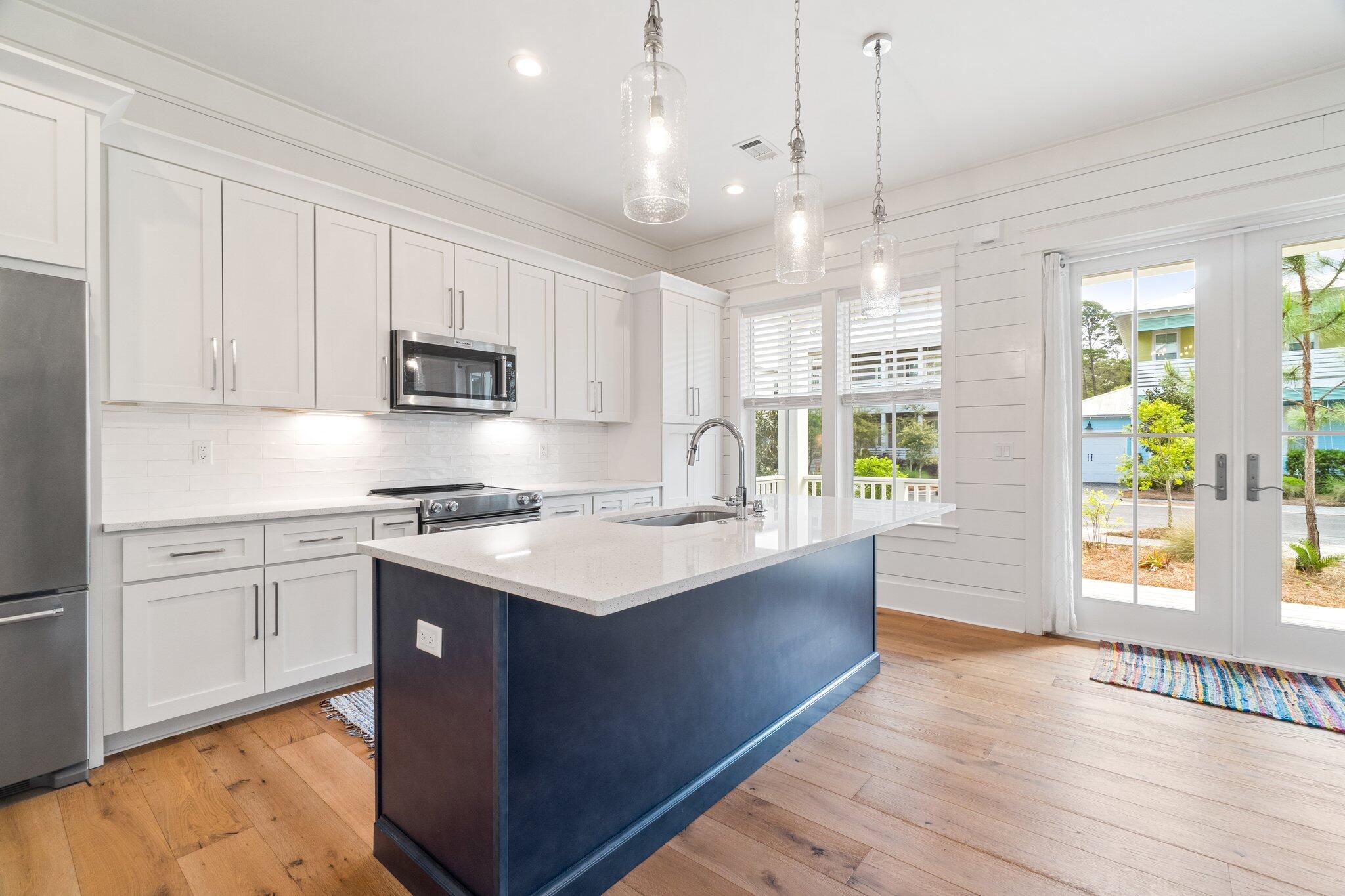 308 Matt's Way Santa Rosa Beach, FL 32459 - Photo 10 of 50 a kitchen with stainless steel appliances granite countertop a sink a stove a refrigerator and island with wooden floor