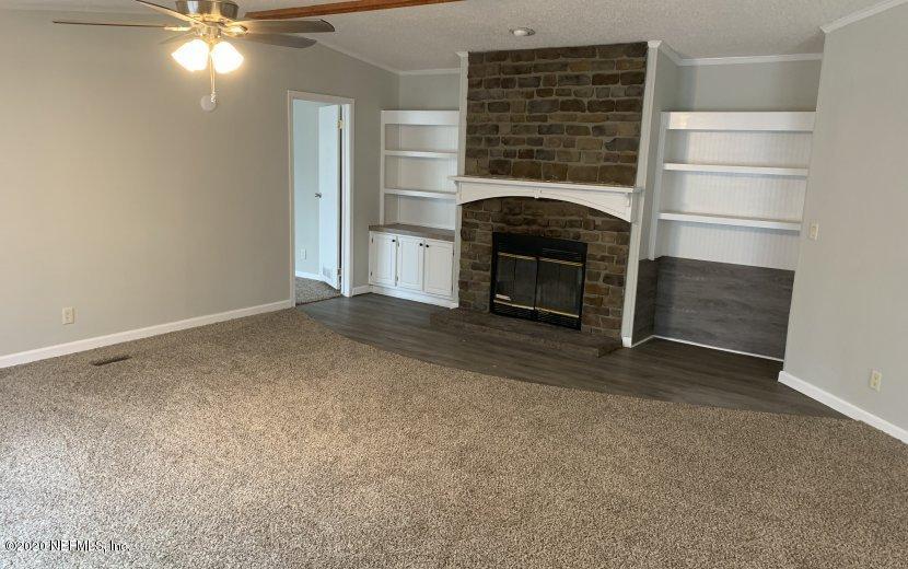 3980 Pinto Road Middleburg, FL 32068 - Photo 14 of 24 a view of an empty room with a fireplace and a window