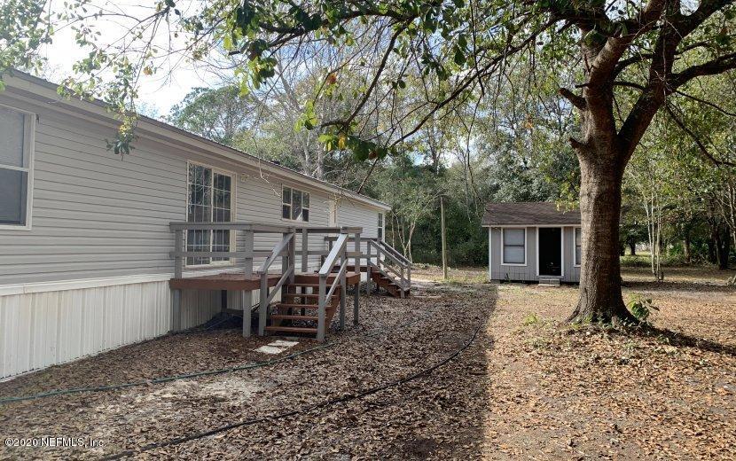 3980 Pinto Road Middleburg, FL 32068 - Photo 16 of 24 a view of a house with backyard and a tree