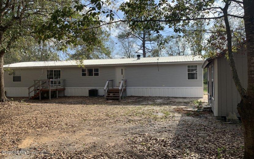 3980 Pinto Road Middleburg, FL 32068 - Photo 17 of 24 a backyard of a house with barbeque oven fire pit table and chairs