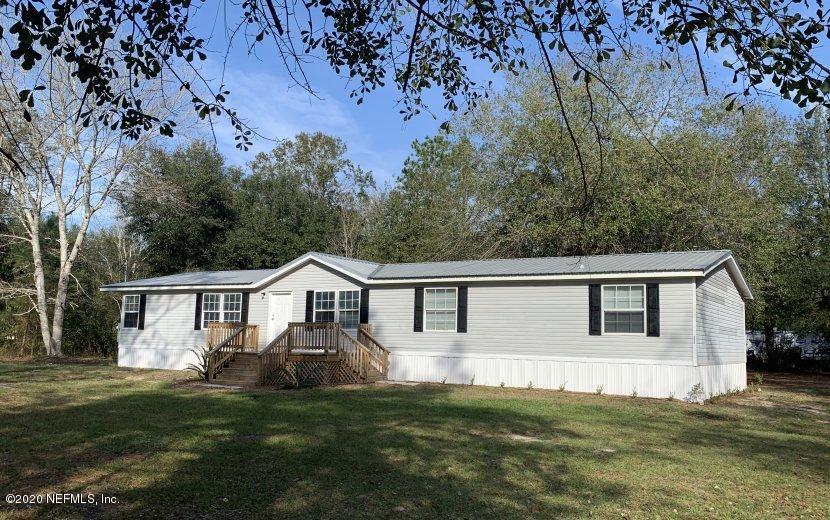 3980 Pinto Road Middleburg, FL 32068 - Photo 2 of 24 a view of a house with a big yard and large trees