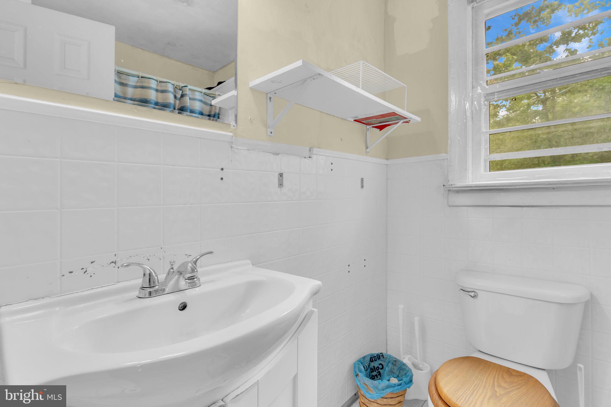 2159 Mathias Point Road King George, VA 22485 - Photo 16 of 22 a bathroom with a sink a toilet and a mirror