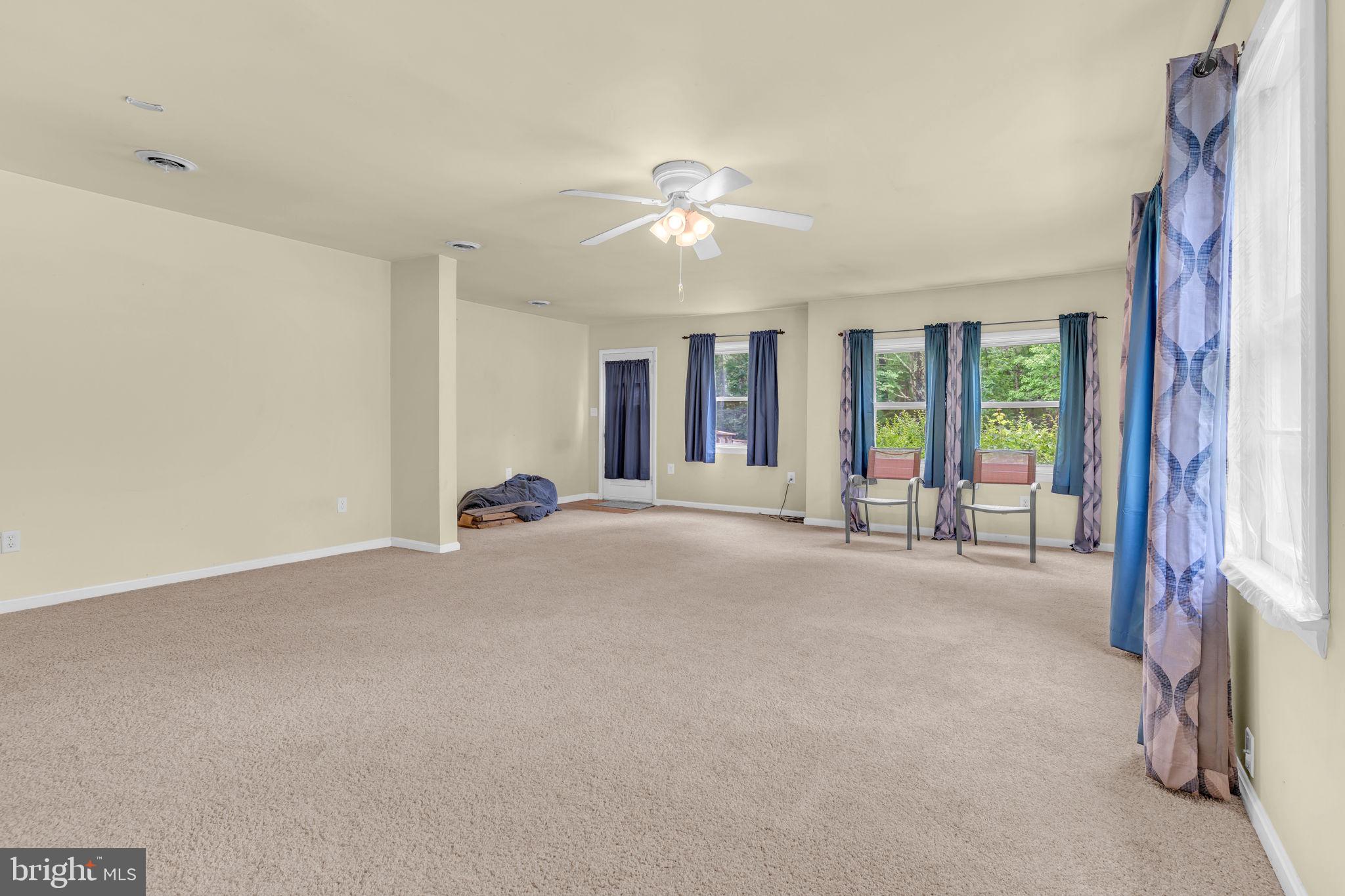 2159 Mathias Point Road King George, VA 22485 - Photo 5 of 22 a view of a livingroom with a ceiling fan and window