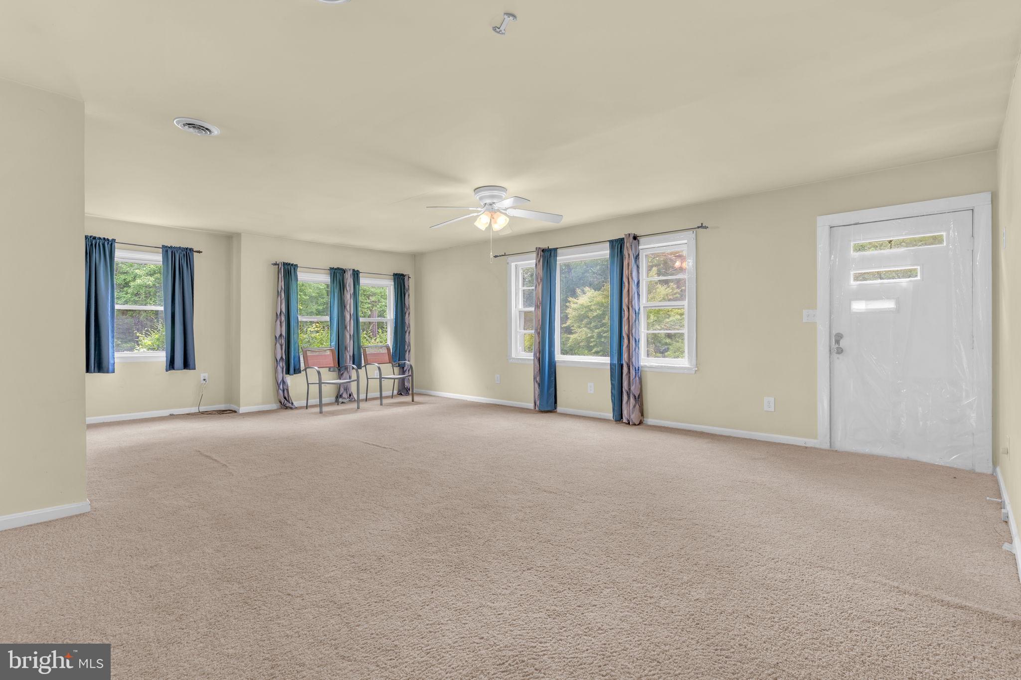 2159 Mathias Point Road King George, VA 22485 - Photo 6 of 22 a view of an empty room with windows and a balcony